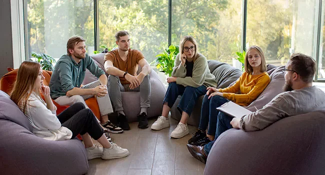 A group therapy session in a bright, welcoming treatment setting
